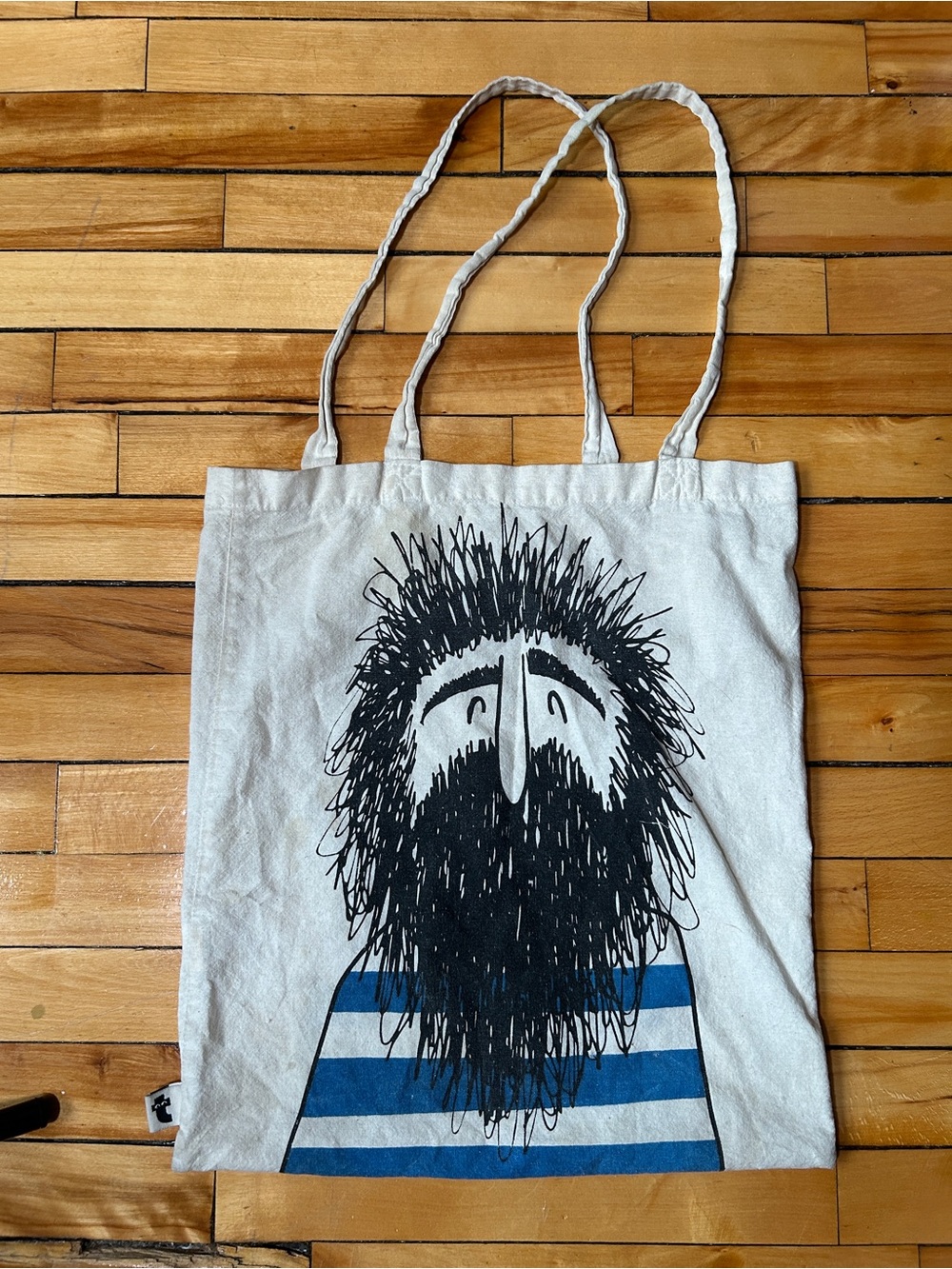 Flying Tiger Copenhagen white canvas tote bearded man and blue striped shirt